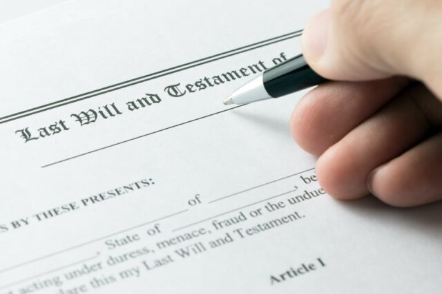 person filling out last will and testament