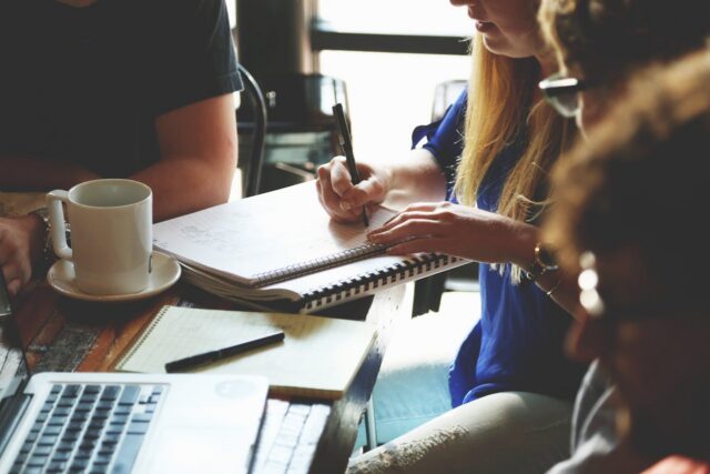 people sitting around a table discussing business