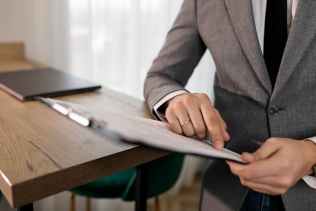 lawyer pointing to document on clipboard